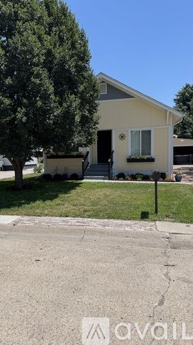 A house with a tree in front of it.