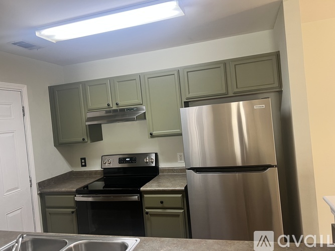 A kitchen with a stainless steel refrigerator and oven.