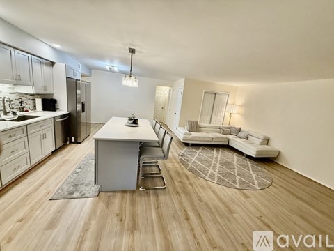 A modern kitchen with a dining area and a living room.