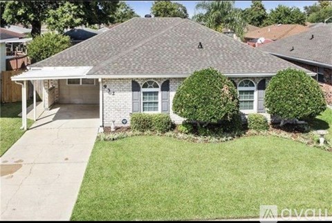 A house with a grey roof and a white garage door.