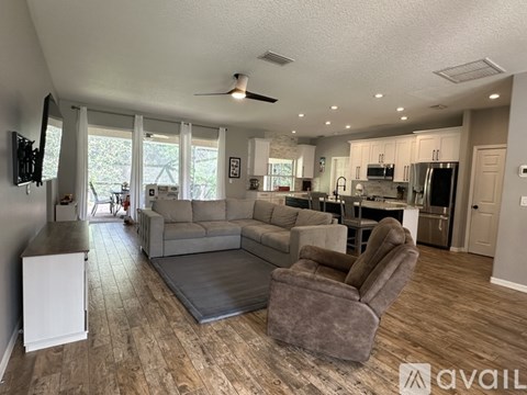 A living room with a grey sofa and a grey armchair.