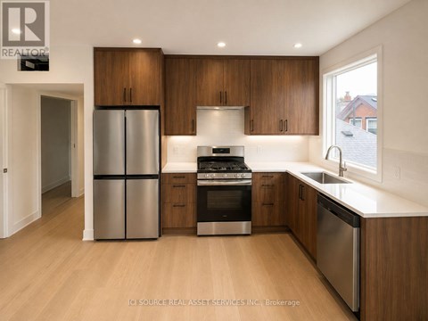 A modern kitchen with wooden cabinets and stainless steel appliances.