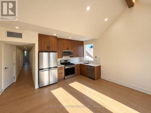 A kitchen with wooden cabinets and stainless steel appliances.