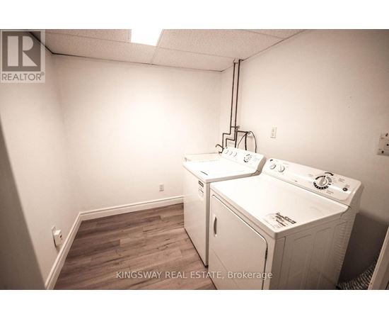 A laundry room with a washer and dryer in it.