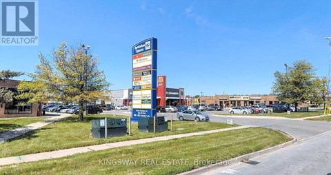 A Kingsway Real Estate sign is displayed in front of a building.