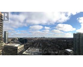 A view of a cityscape from a high vantage point with the text "REMAX WEST REALTY INC. Brokerage" visible.
