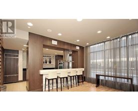 A well-lit kitchen with a dining table and chairs.