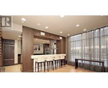 A well-lit kitchen with a dining table and chairs.