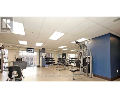 A gym with a variety of equipment including treadmills, weights, and exercise machines.