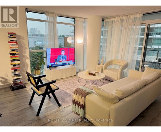 A living room with a large screen and a couch.