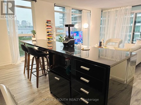 A black and white kitchen with a large island and a view of the city.