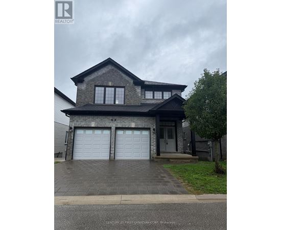 A house with a grey roof and two garage doors.