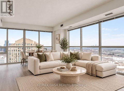 A living room with a large window overlooking a cityscape.