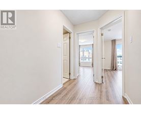 A hallway with a door on the left and a window on the right.