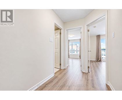 A hallway with a door on the left and a window on the right.