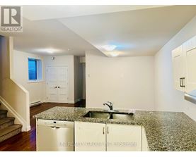 A kitchen with granite countertops and a sink.