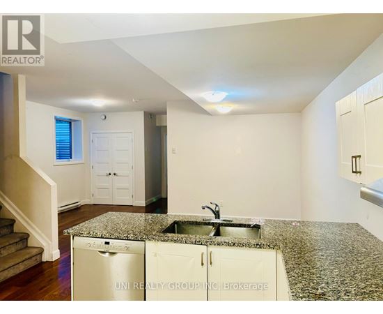 A kitchen with granite countertops and a sink.