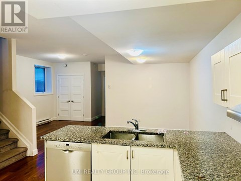 A kitchen with granite countertops and a sink.