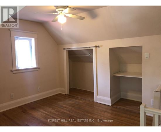 A room with a ceiling fan and a window.
