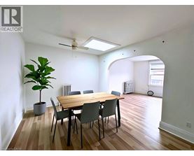 A dining room with a table and chairs.