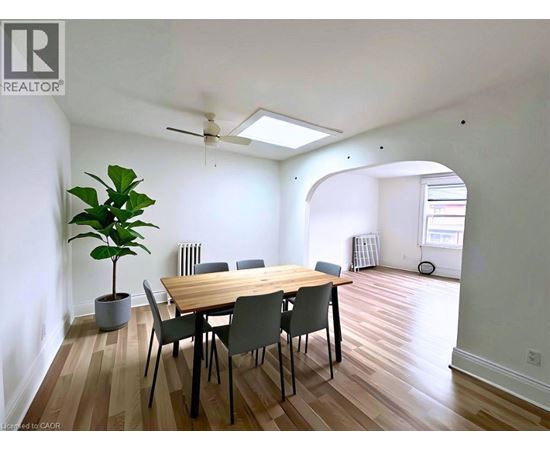 A dining room with a table and chairs.