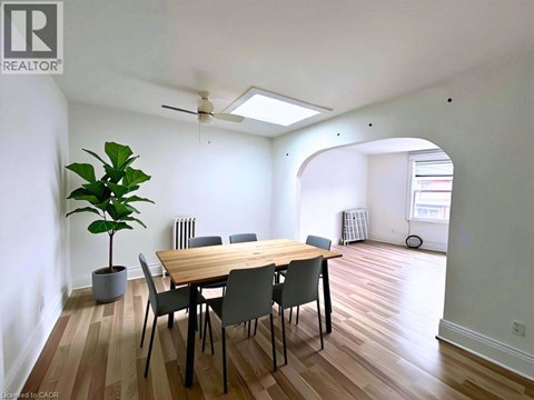 A dining room with a table and chairs.