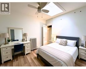 A bedroom with a bed, desk, and chair.