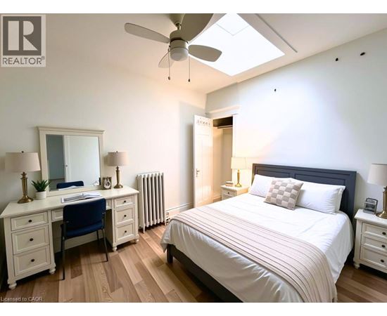 A bedroom with a bed, desk, and chair.