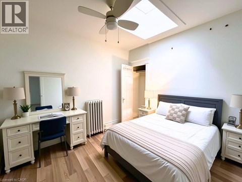 A bedroom with a bed, desk, and chair.