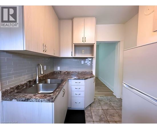 A kitchen with a sink and cabinets.