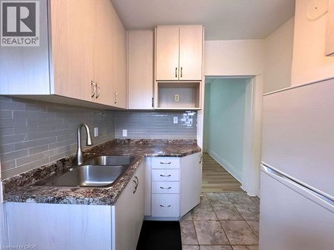 A kitchen with a sink and cabinets.