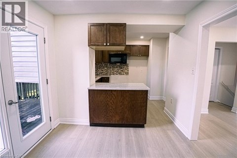 A white room with a wooden cabinet and a counter.