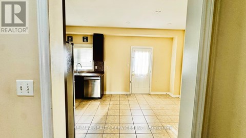 A room with a white door and a window with blinds.
