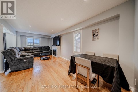 A living room with a grey couch and a black tablecloth on the table.