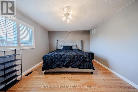 A bedroom with a bed and a chandelier.