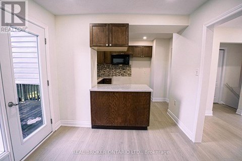 A kitchen area with a counter and cabinets.