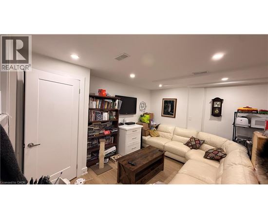 A living room with a couch, a coffee table, and a bookshelf.