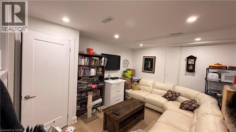 A living room with a couch, a coffee table, and a bookshelf.