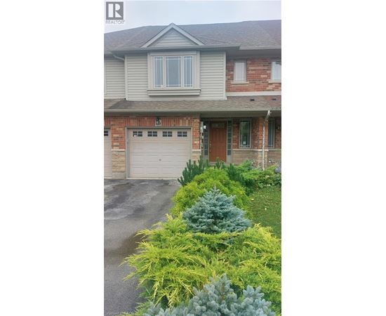 A house with a grey roof and a garage door.