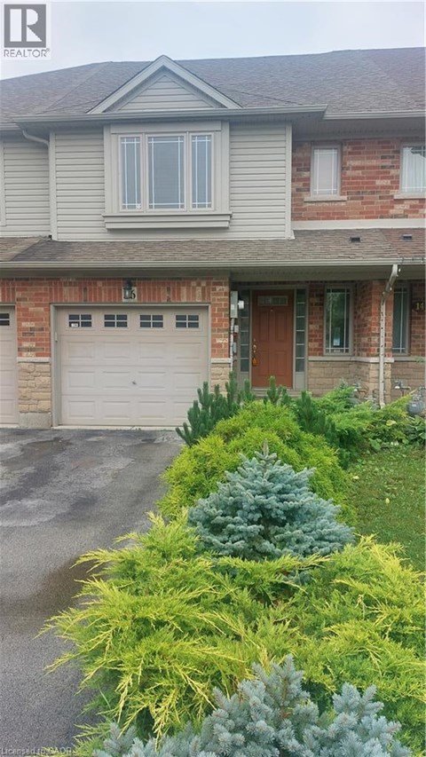 A house with a grey roof and a garage door.