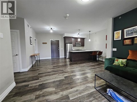 A living room with a kitchen area in the background.