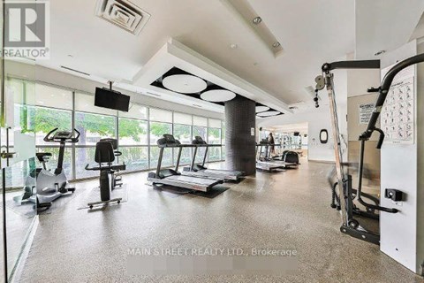 A gym with treadmills, elliptical machines, and other exercise equipment.