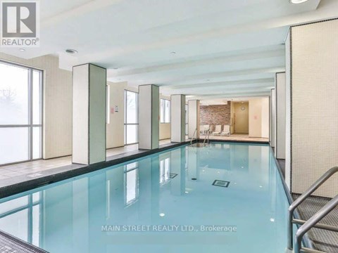 A swimming pool inside a building with a glass bottom.