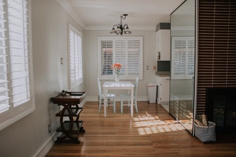 A dining room with a table and chairs.