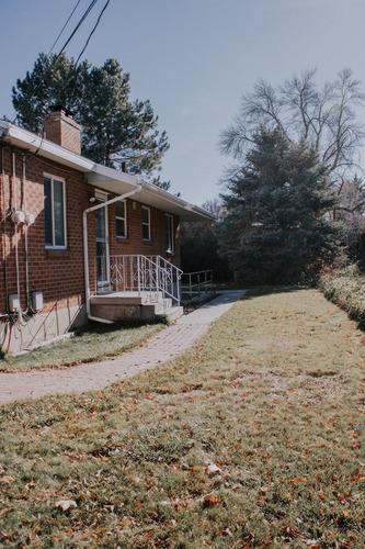 A house with a brick exterior and a deck.