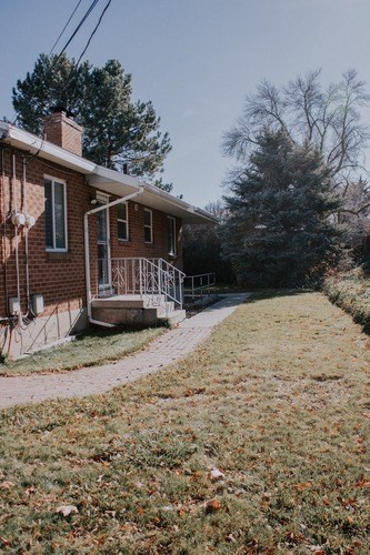 A house with a brick exterior and a deck.
