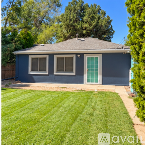 A house with a blue exterior and a green door.