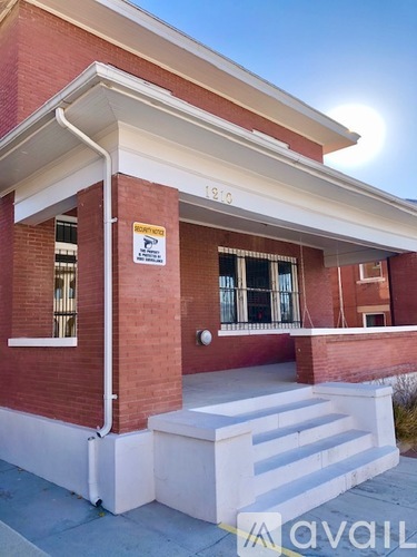 A red brick building with a sign that says "AVAILABLE".