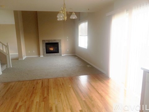 A living room with a fireplace and a chandelier.
