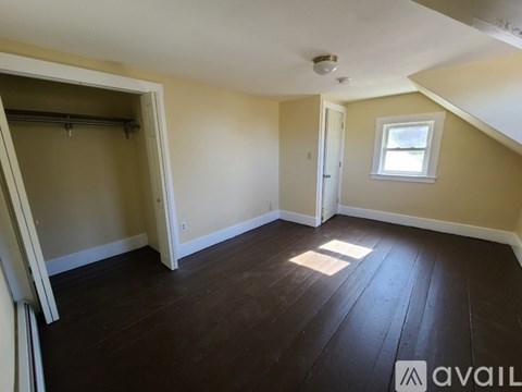 A room with wooden floors and a window on the wall.
